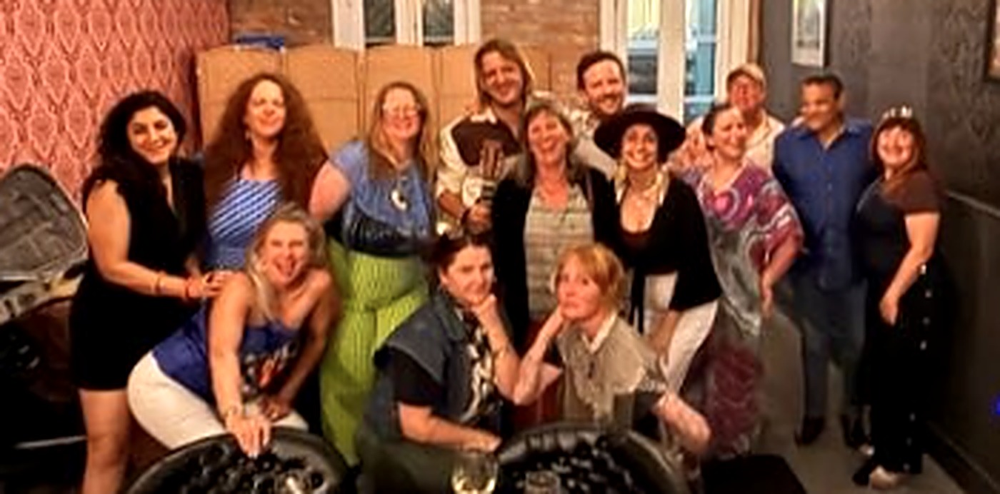 The Live Music Besties crew and friends smiling together at a dinner gathering.